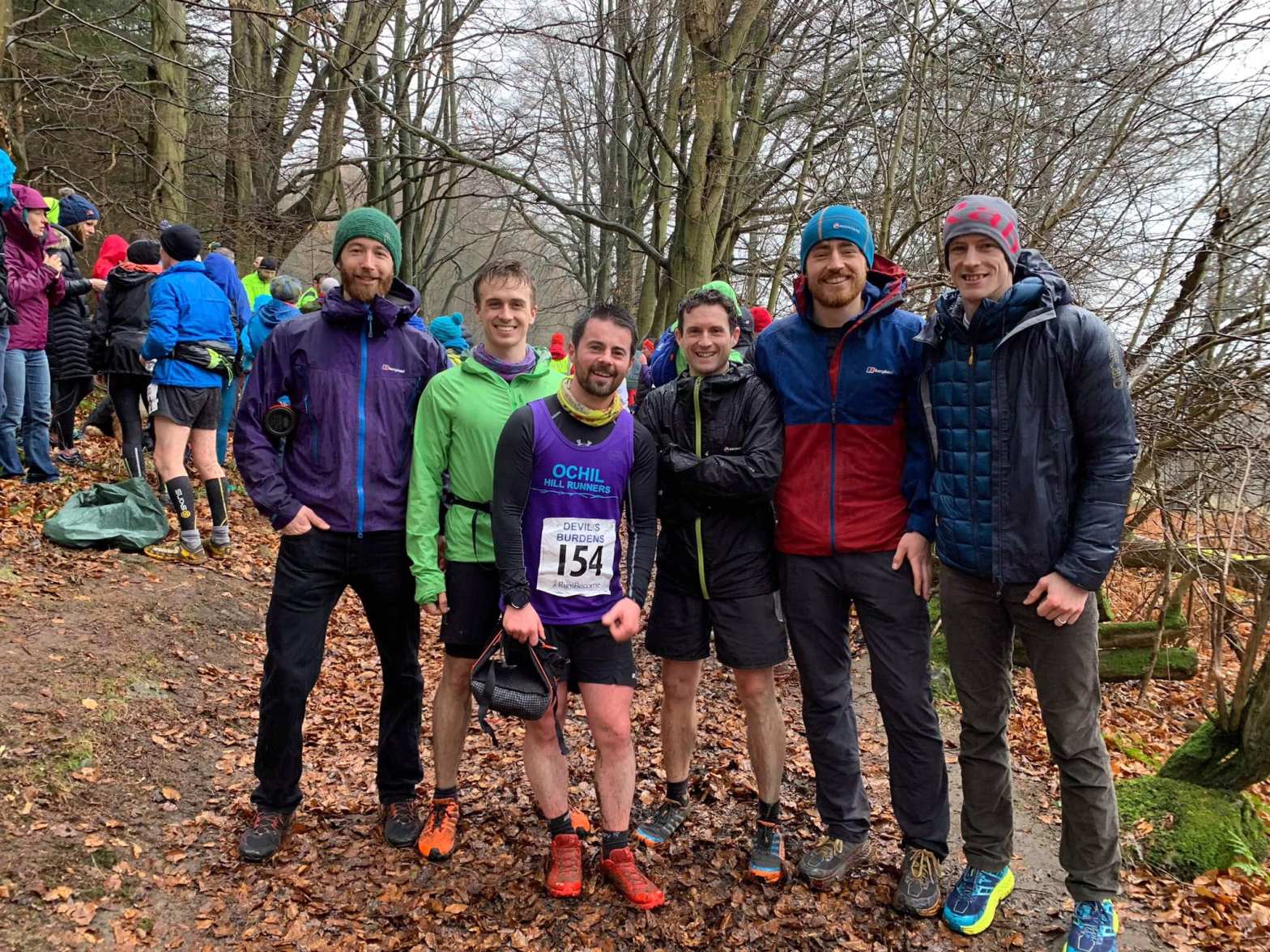 Runners posing after a race as a team.