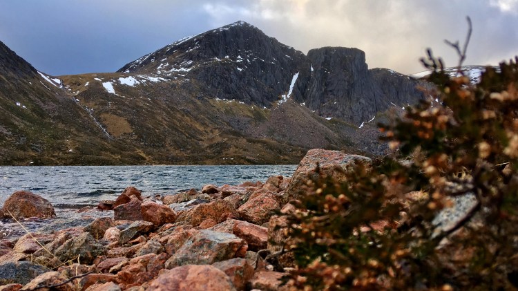 Lochside photo looking up to cragged mountain.